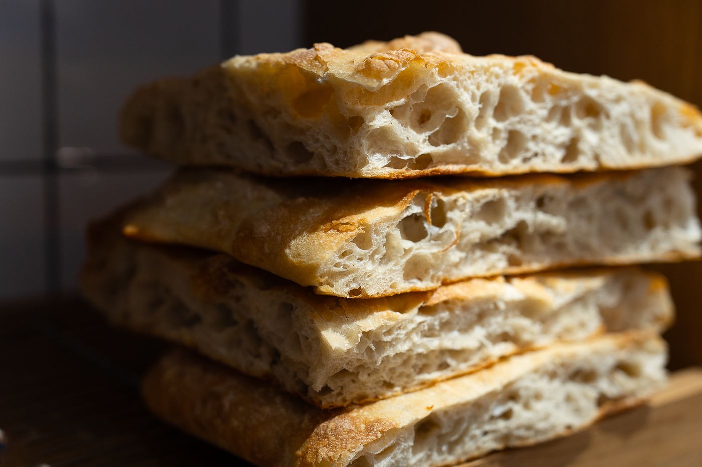 Freshly cut focaccia stacked on a board
