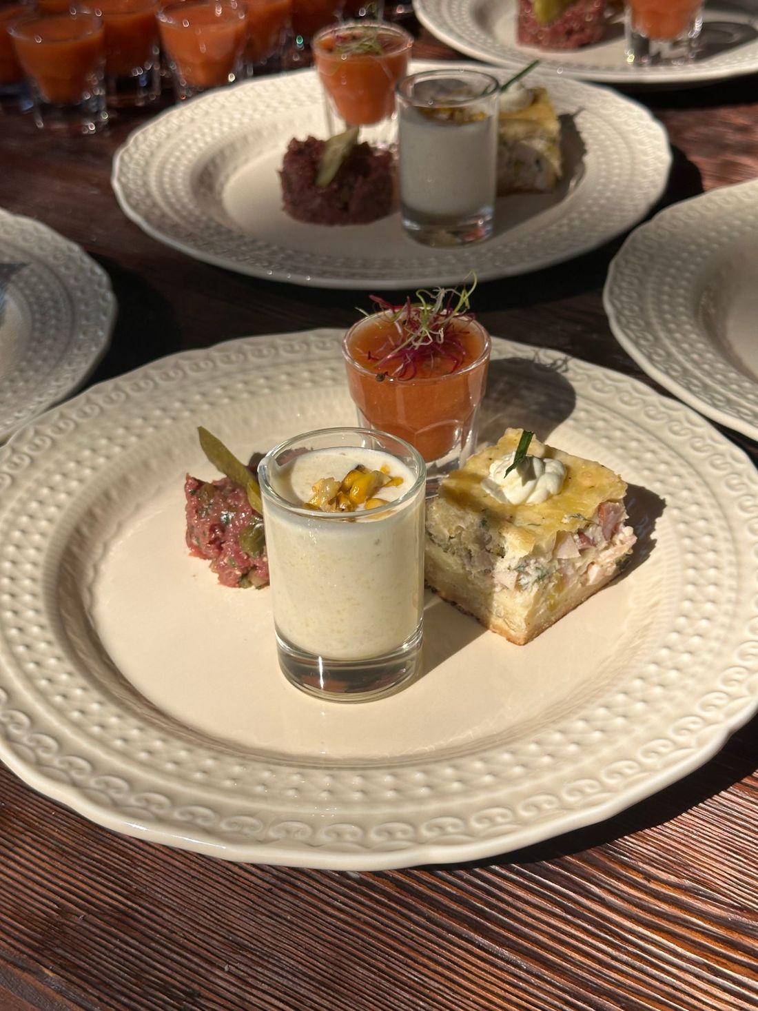 The same tasting plate in low sun, with more plates lined up behind